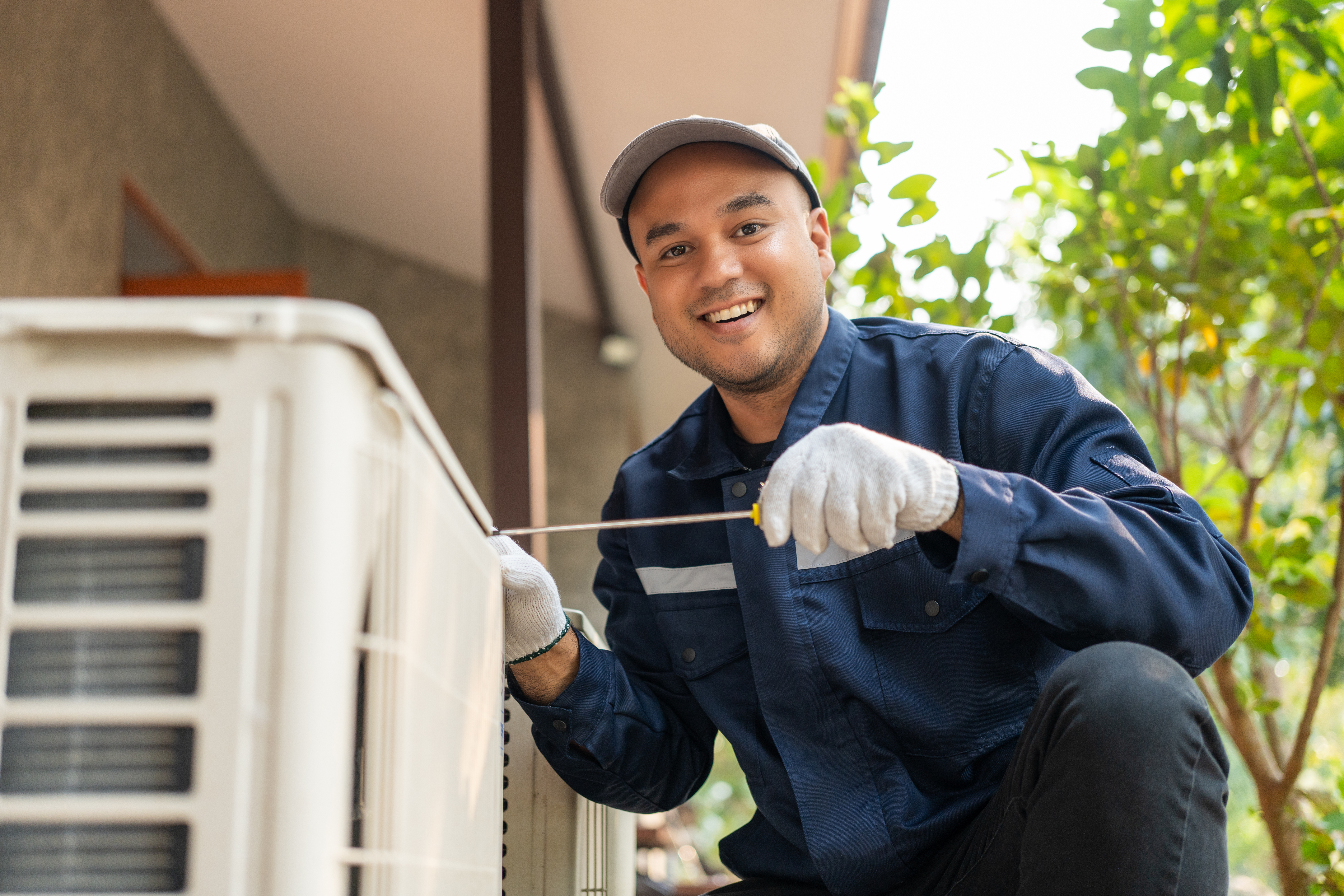 Service technician checking air conditioner
