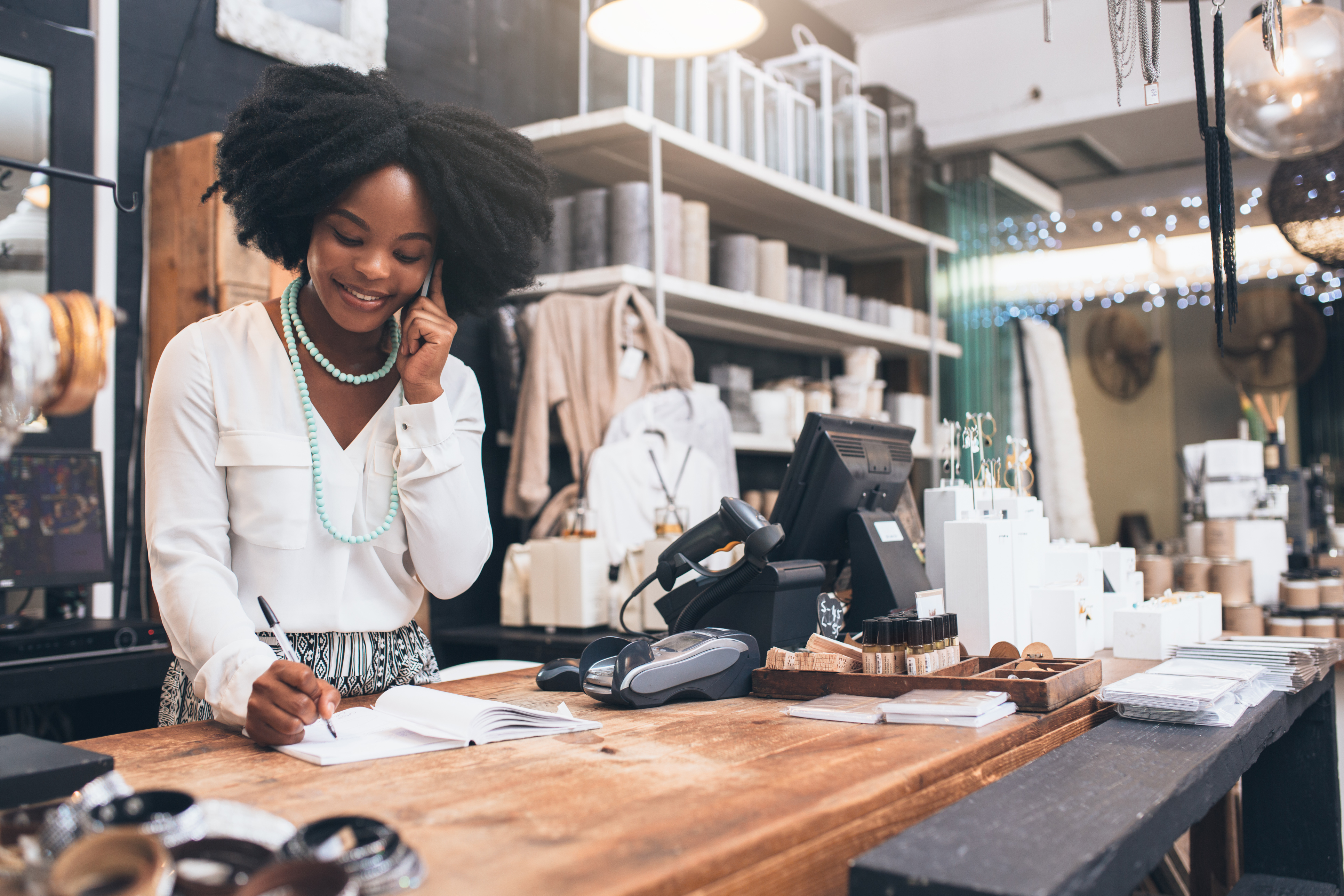 Woman standing behind a desk talks on the phone