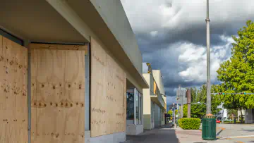 Boarded up windows and an approaching storm