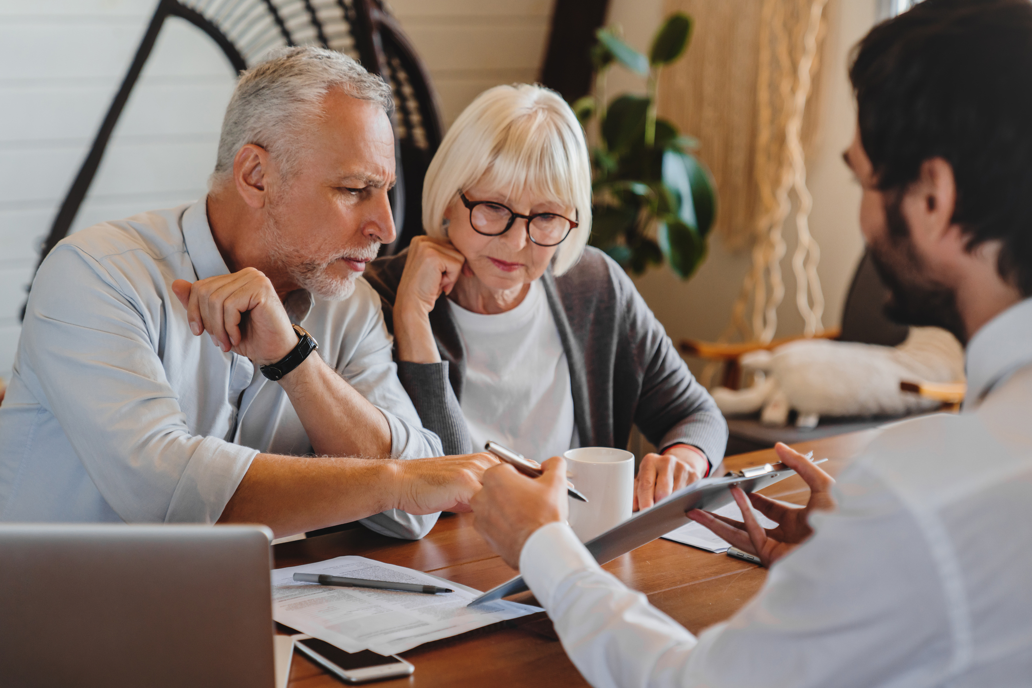 Couple reviewing finances with advisor
