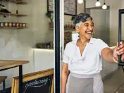 Business owner opens the door to her store