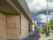 Boarded up windows and an approaching storm