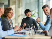 People sit around a conference table 