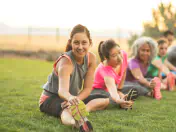 Fitness enthusiasts stretch in the park