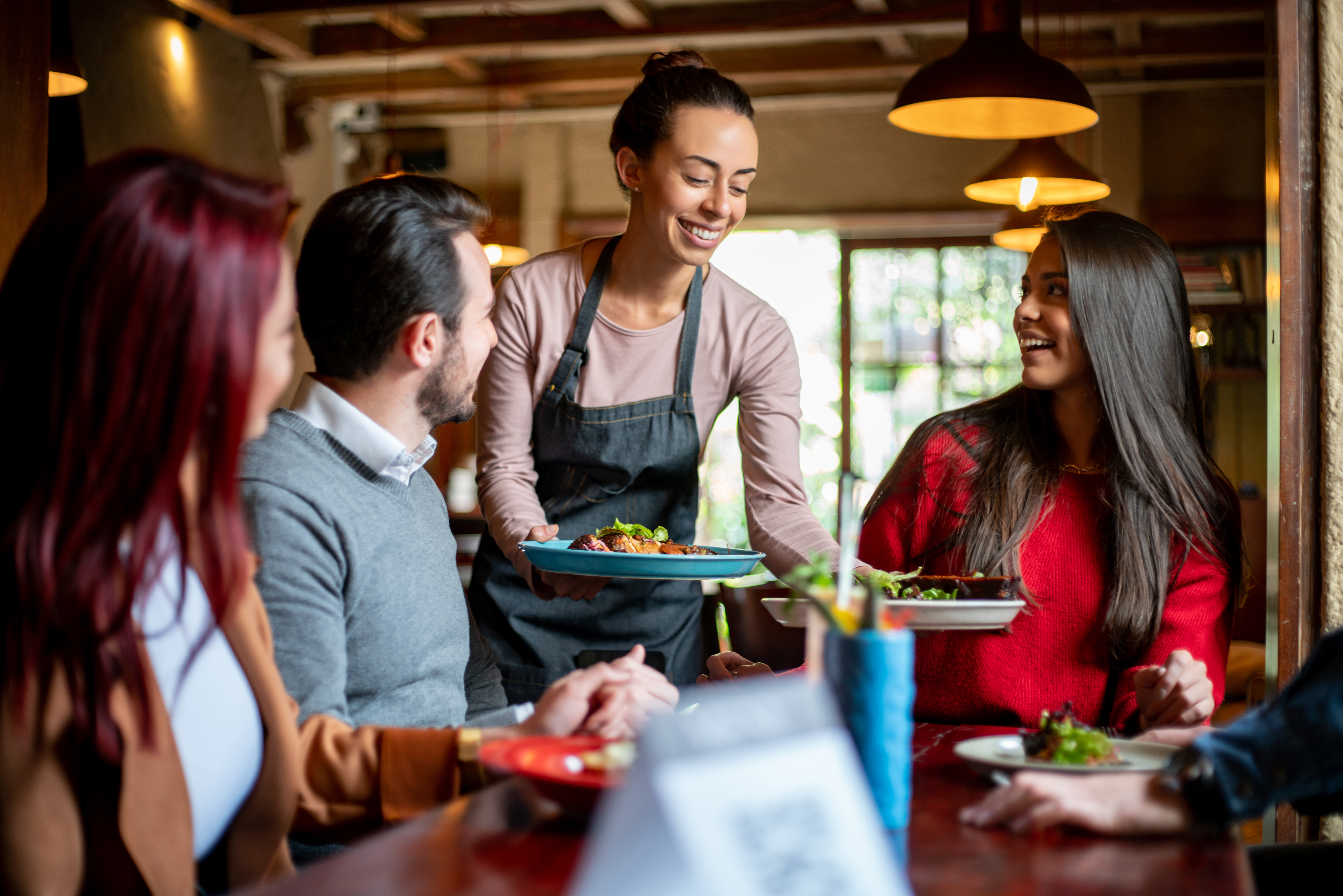 Waitress handing people food